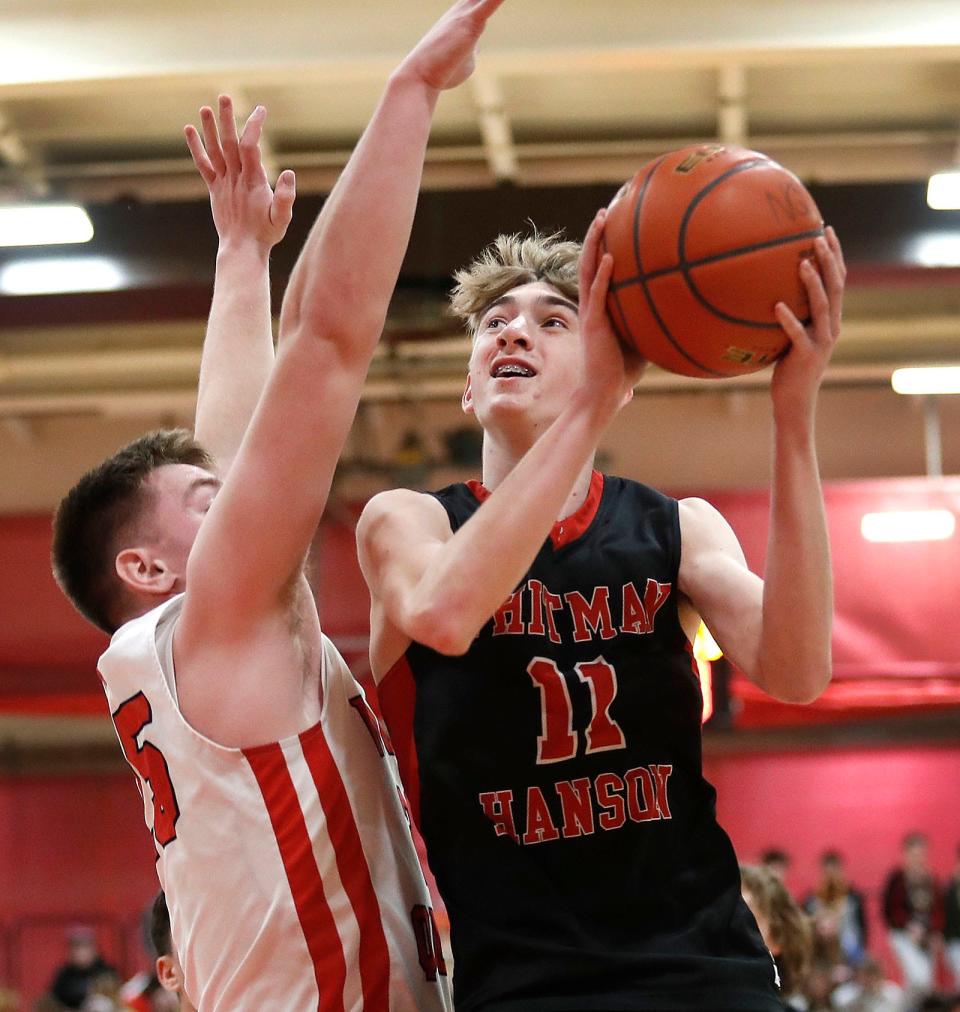 Panther sophomore forward Ryan Baker lays up a shot over Raider Dylan Clifford.North Quincy hosted Whitman-Hanson in MIAA tournament action narrowly beating W-H by one point on a free throw with less than a second to play on Friday March 3, 2023 