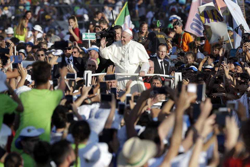 Pope Francis arrives at Rome's Circus Maximus to lead an evening prayer vigil with youths, Saturday, Aug. 11, 2018. Thousand of youths gathered for the meeting with the pontiff in preparation for the next World Youth Day that will be held in Panama next year. (AP Photo/Andrew Medichini)