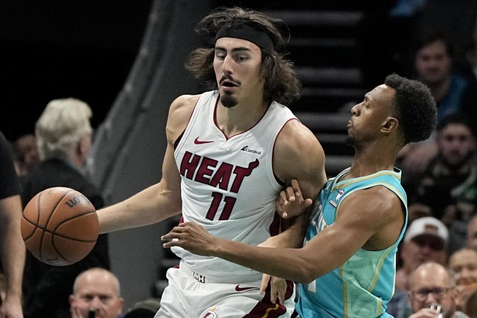 Hornets guard Ish Smith, right, pressures Heat guard Jaime Jaquez Jr. during a game.