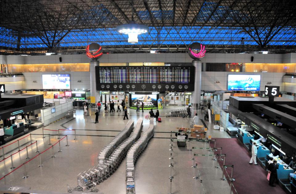 Taipei, Taiwan / Formosa / ROC (Republic of China): interior of Terminal 2 of Taiwan Taoyuan International Airport - international airport serving Taipei and northern Taiwan - located west of Taipei in Dayuan District, Taoyuan - formerly known as Chiang Kai-shek International Airport (CKS International Airport) - baggage carts, check-in counters and departures board