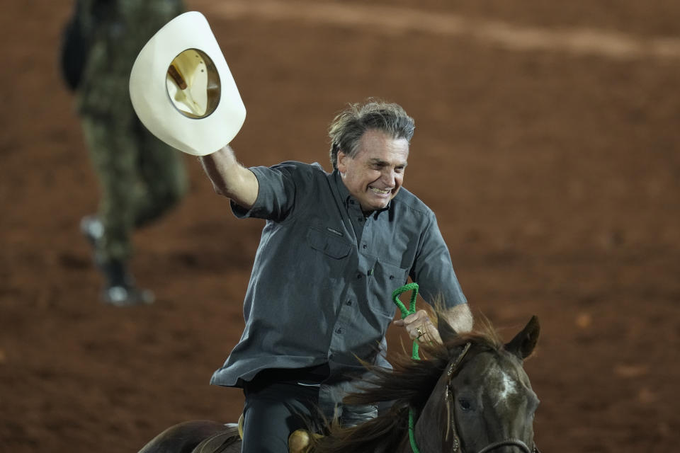 Brazilian President Jair Bolsonaro, who is running for a second term, rides a horse at the the Barretos Rodeo International Festival in Barretos, Sao Paulo state Brazil, Friday, Aug. 26, 2022. Brazil's general elections are scheduled for Oct. 2, 2022. (AP Photo/Andre Penner)