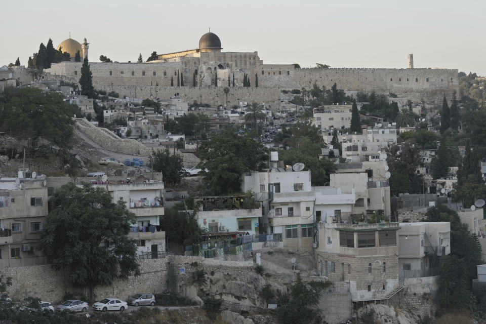 A view of the Al-Aqsa mosque compound above the Silwan neighbourhood of east Jerusalem, Friday, Aug. 26, 2022. A group of artists has filled a Palestinian area of east Jerusalem with paintings of large, wide-open eyes. The murals are a reminder that all eyes are on the neighborhood of Silwan, a flashpoint where Palestinians say Israeli forces and settlers are working to drive them out of their homes. (AP Photo/ Mahmoud Illean)