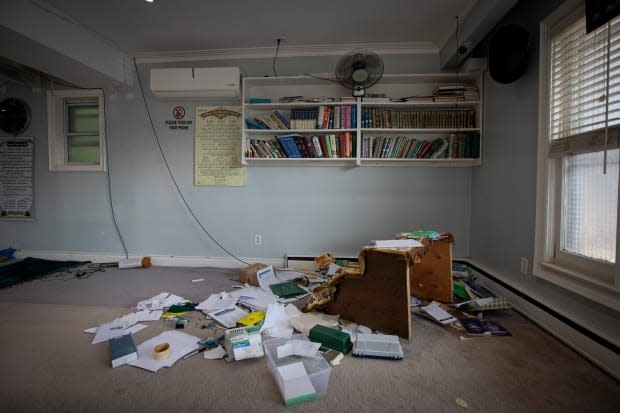 Ransacked paperwork and religious texts left on the floor of the Baitul Jannah Islamic Centre are pictured on Aug. 23, 2021. The mosque was broken into and vandalized over the weekend. (Evan Mitsui/CBC - image credit)