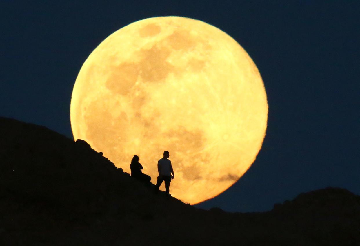 The supermoon, also known as the pink moon rises over the Papago Park Buttes in Phoenix on April 7, 2020. It was the biggest and brightest supermoon of 2020.