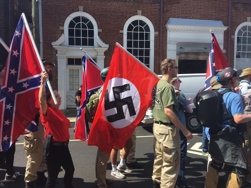 "Unite the Right" protestors gather in Charlottesville carrying flags emblazoned with&nbsp;swastikas. (Photo: Andy Campbell)