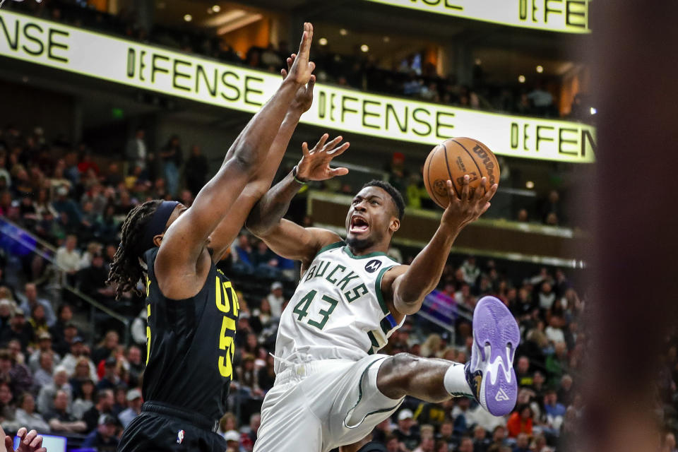 Milwaukee Bucks forward Thanasis Antetokounmpo (43) shoots after running into Utah Jazz forward Jarrell Brantley (55) during the second half of an NBA basketball game Friday, March 24, 2023, in Salt Lake City. (AP Photo/Adam Fondren)