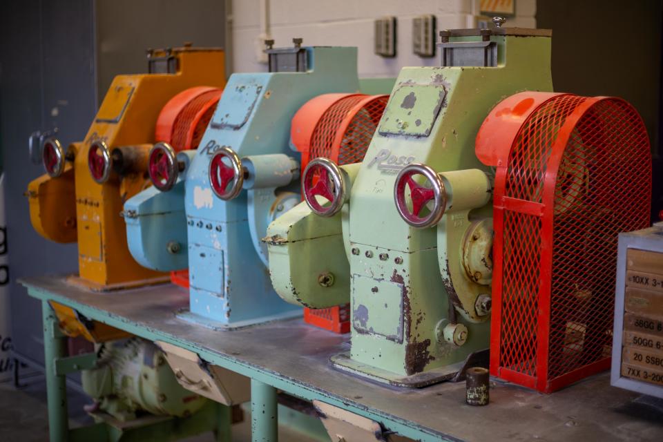 Milling science students in K-State's College of Agriculture work on antiquated rolling mills in Shellenberger Hall.