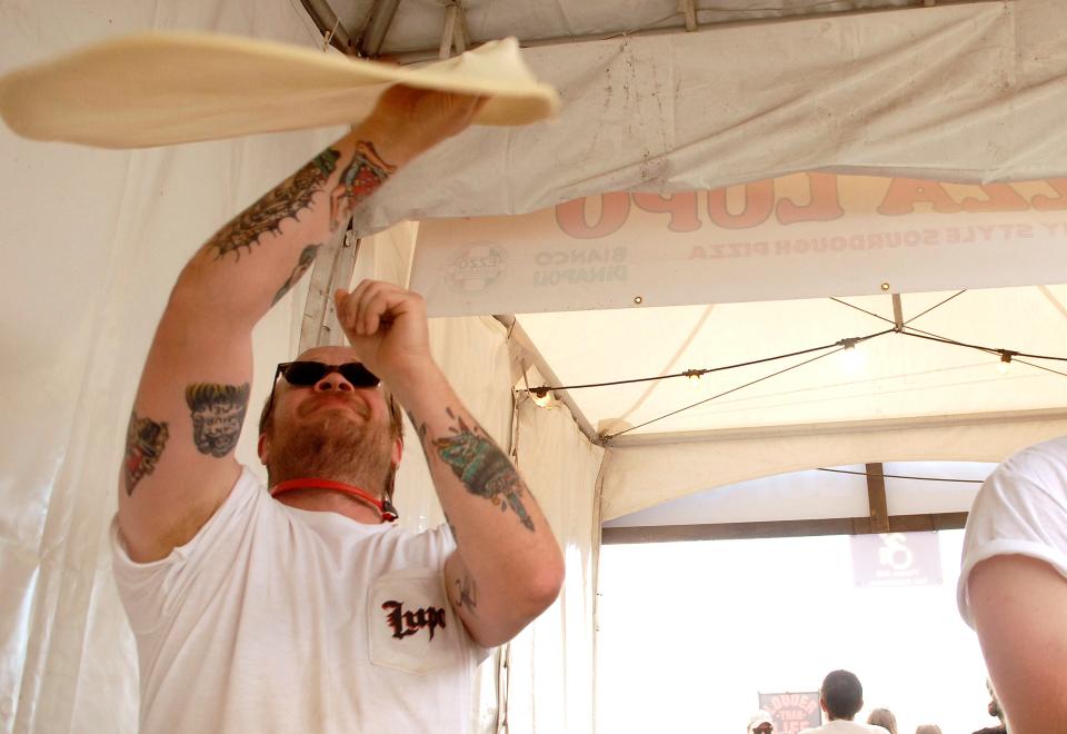 Max Balliet of Pizza Lupo throws pizza dough at Louder Than Life on Sunday. Sept. 24, 2023