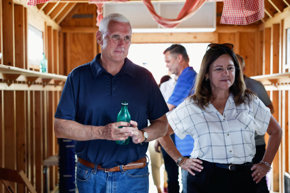 Former Vice President Mike Pence walks next to his wife, Karen, at the Iowa State Fair.