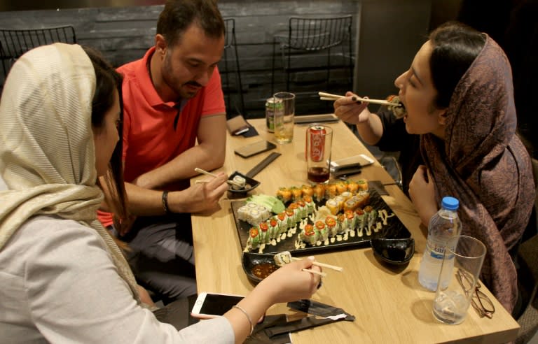 Iranians eat out at a high-end French sushi chain that opened this month in northern Tehran