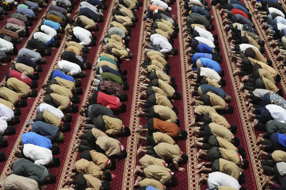 Muslim men perform midday prayer at Istiqlal Mosque whose electricity partially come from solar power in Jakarta, Indonesia, Wednesday, March 29, 2023. A major renovation in 2019 installed upwards of 500 solar panels on the mosque's expansive roof, now a major and clean source of Istiqlal's electricity. (AP Photo/Tatan Syuflana)