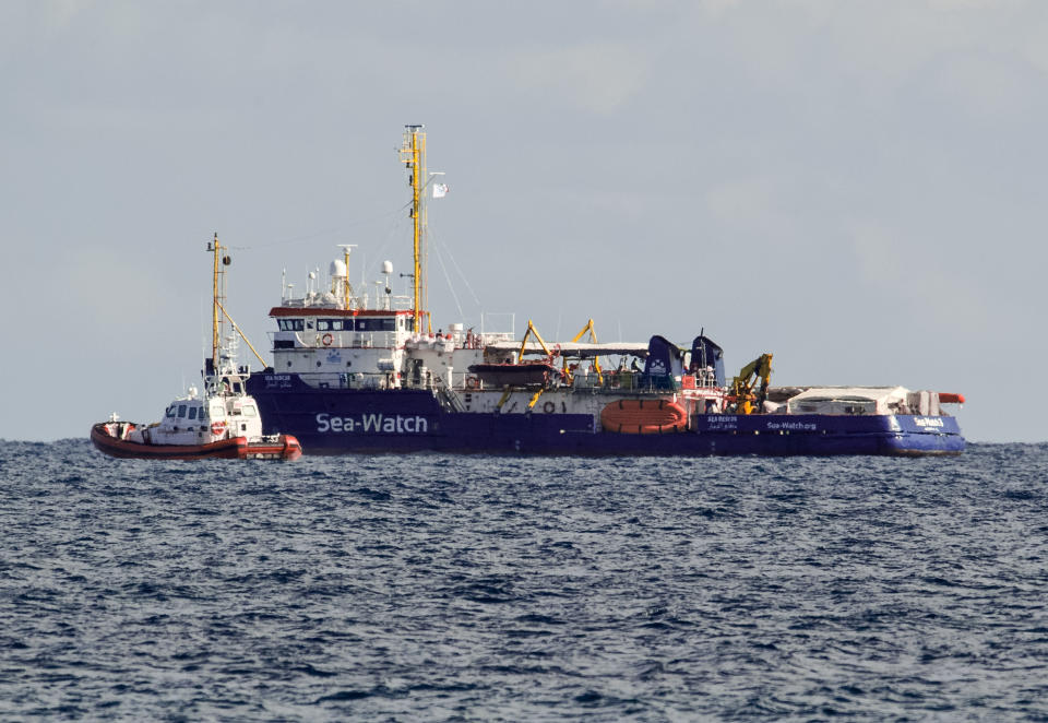 An Italian Coast Guard patroller flanks the Sea-Watch rescue ship off the Sicilian coast where it found shelter, about one nautical mile from Siracusa, from gale winds sweeping the Sicilian Channel, Friday, Jan. 25, 2019. The Sea-Watch is carrying 47 people saved from the sea. Italian Interior minister Salvini yesterday tweeted that the government is "ready to send food, medicine and whatever may be needed, but Italy's ports are and will remain closed". (AP Photo/Salvatore Cavalli)