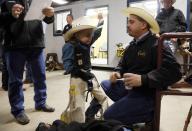 CeJay Jones, 6, practices holding on with his father Chris (R) looking on before he competed in the mini bull riding competition at the 108th National Western Stock Show in Denver January 11, 2014. The show, which features more than 15,000 head of livestock, opened on Saturday and runs through January 26. REUTERS/Rick Wilking (UNITED STATES - Tags: ANIMALS SOCIETY)