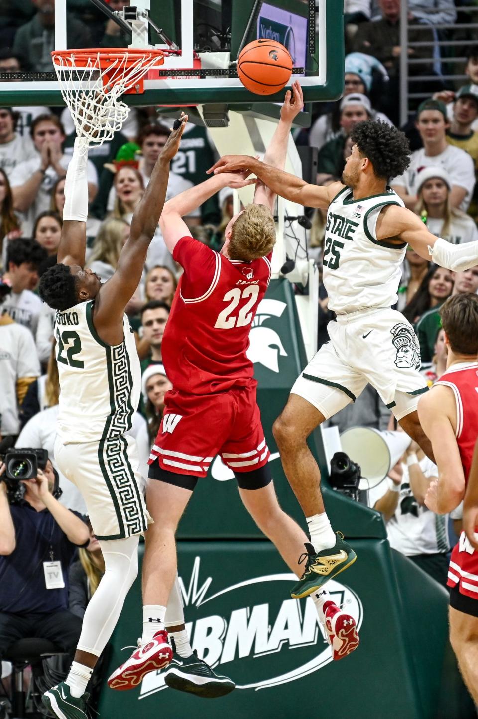 Michigan State's Mady Sissoko, left, and Malik Hall, right, block a shot by Wisconsin's Steven Crowl during the first half on Tuesday, Dec. 5, 2023, at the Breslin Center in East Lansing.