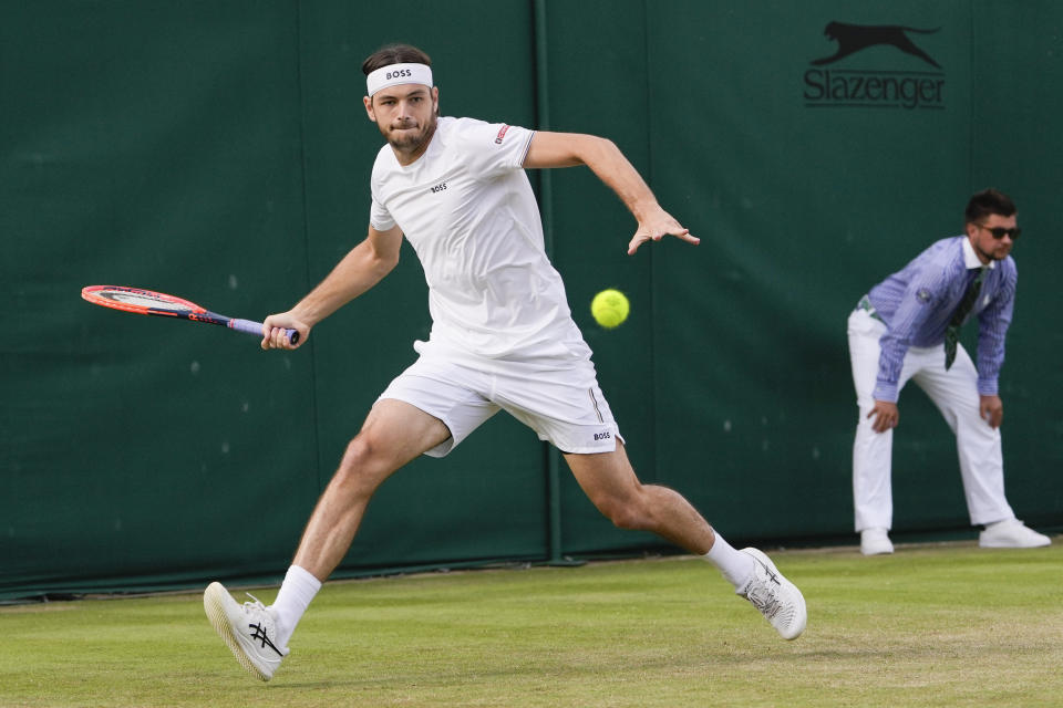 Taylor Fritz of the United States plays a forehand return to Arthur Rinderknech of France during their second round match at the Wimbledon tennis championships in London, Thursday, July 4, 2024. (AP Photo/Alberto Pezzali)