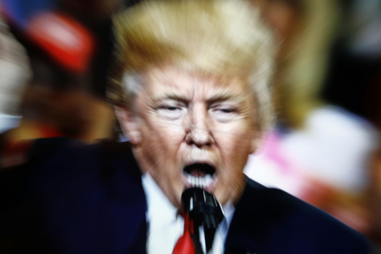 A slow shutter speed image of former US president Donald Trump on a TV screen is seen in this photo illustration in Warsaw, Poland on 23 February, 2022. (Photo by STR/NurPhoto via Getty Images)