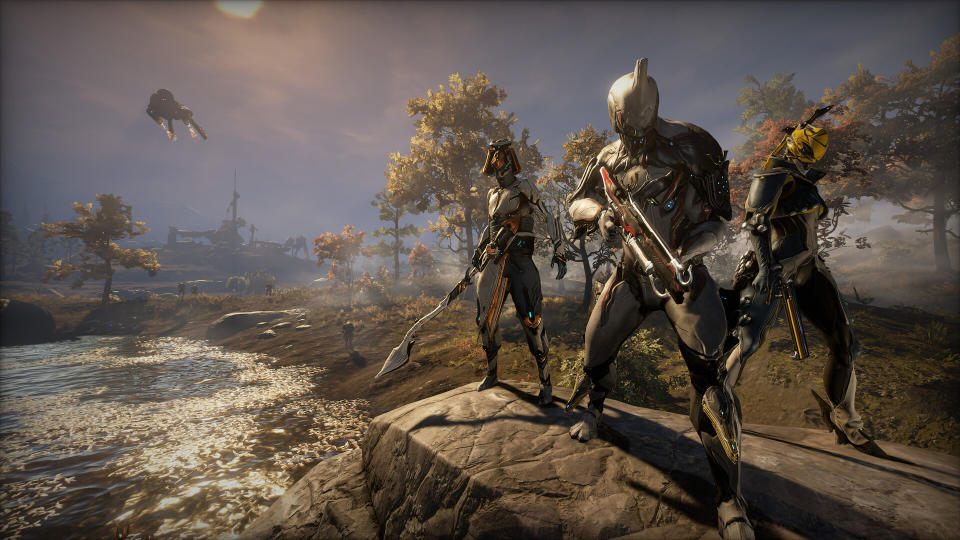 Three white Warframes pose on a rock