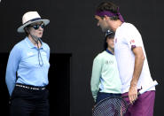 FILE - In this Jan. 28, 2020 file photo, Switzerland's Roger Federer, right, questions a line judge during his quarterfinal against Tennys Sandgren of the U.S. at the Australian Open tennis championship in Melbourne, Australia. In a Grand Slam-first, at the 2021 Australian Open tennis championships, there will be no on-court line judges on any of the tournament courts in an effort to reduce the number of staff on-site due to coronavirus-related concerns. Only chair umpires and ball persons will be on the court. (AP Photo/Andy Brownbill,File)