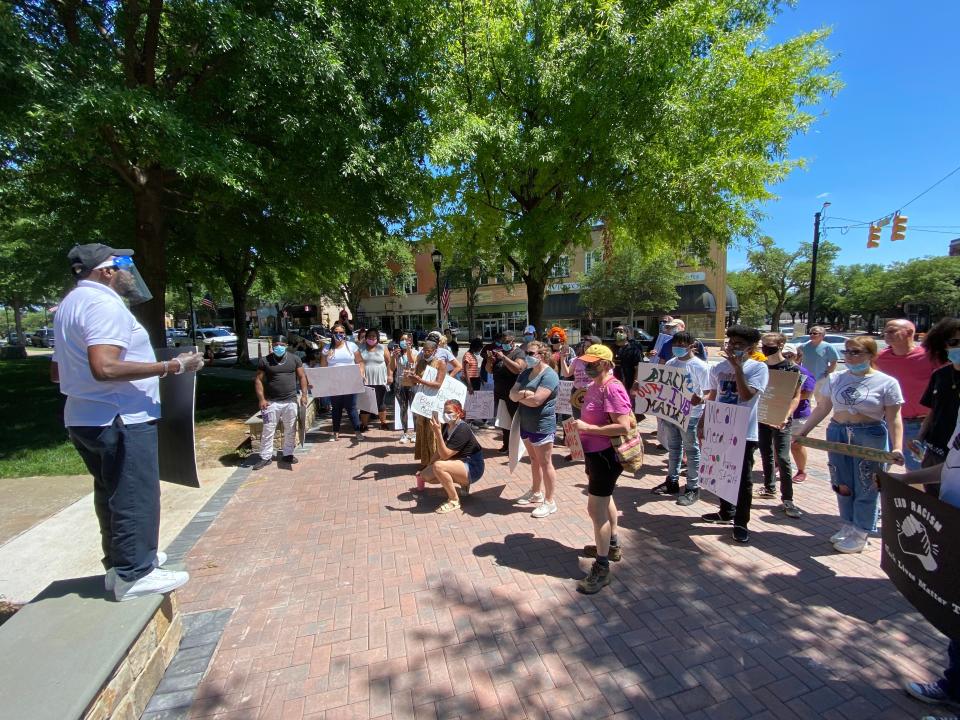 The Rev. Billy Houze speaks to a group of protesters that assembled Sunday.