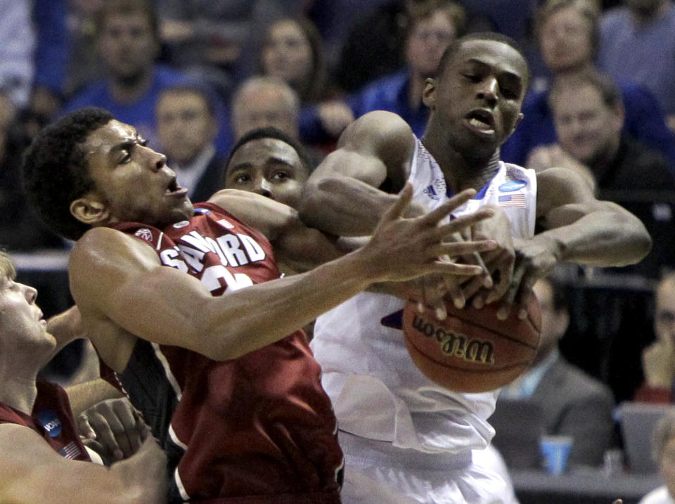 Kansas' Andrew Wiggins, right, and Stanford's Josh Huestis reach for a rebound during the first half of a third-round game of the NCAA college basketball tournament Sunday, March 23, 2014, in St. Louis. (AP Photo/Jeff Roberson)