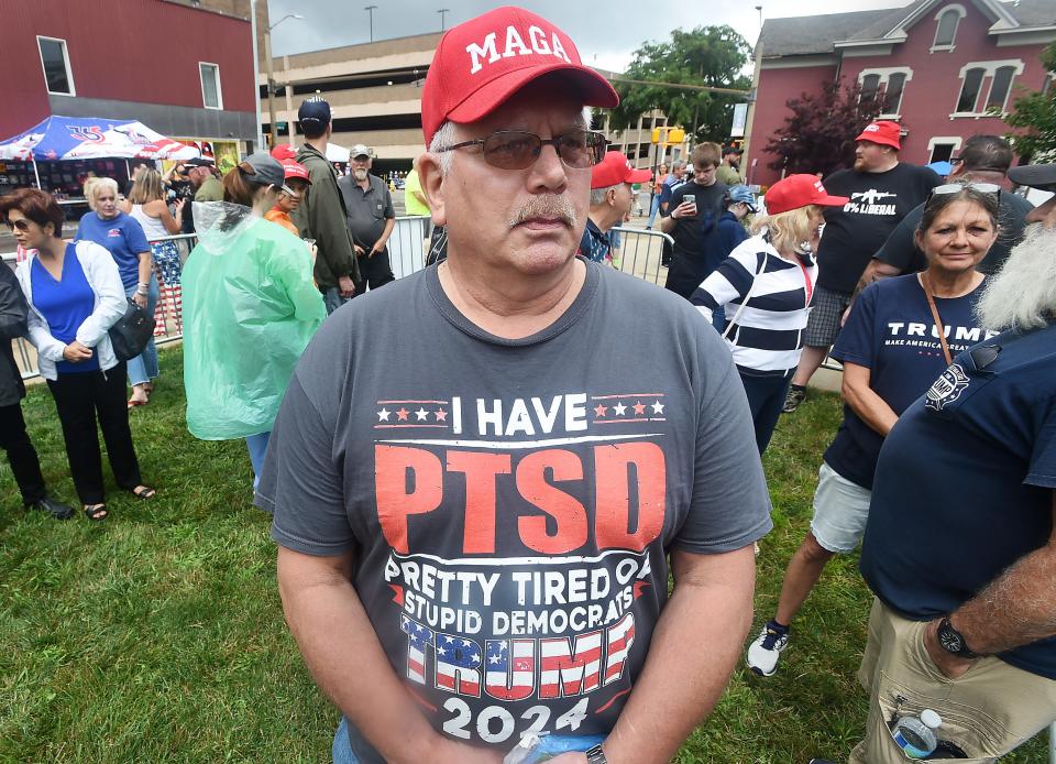 Barry Hughes, 64, waits outside Erie Insurance Arena prior to the Donald Trump rally in Erie on Saturday. Hughes, attending his first Trump rally, is from Sheffield, Pa.