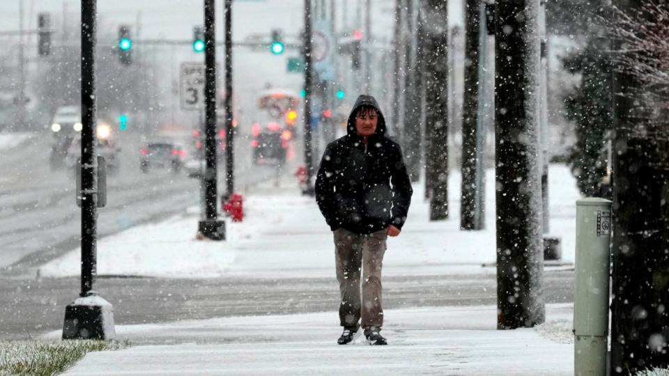 PHOTO: Pedestrian walks on a snow-covered sidewalk in Wheeling, Ill., Jan. 9, 2024.  (Nam Y. Huh/AP)