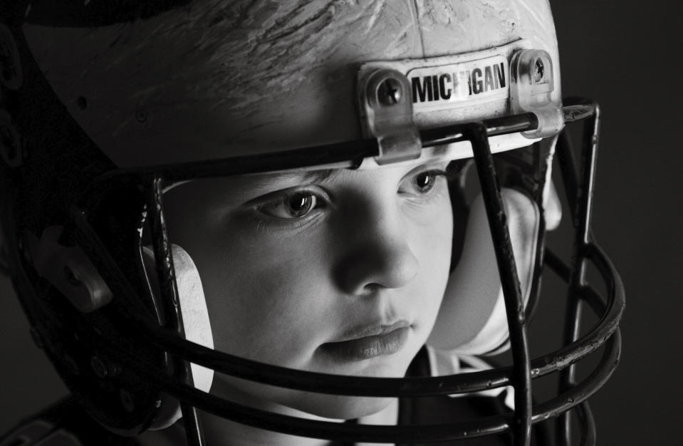 In a photo provided by Melissa Hutchinson, Aidan Hutchinson wears a Michigan football helmet. Jacksonville is expected to select Hutchinson with the No. 1 pick in the NFL draft on Thursday night, April 28. It's easy to see why the Jaguars would want him after watching what Hutchinson did last year at Michigan. Scouts who searched for more about his background found out Chris and Melissa raised a well-rounded son, uniquely shaped by a close-knit family that includes two older sisters. (Melissa Hutchinson via AP)