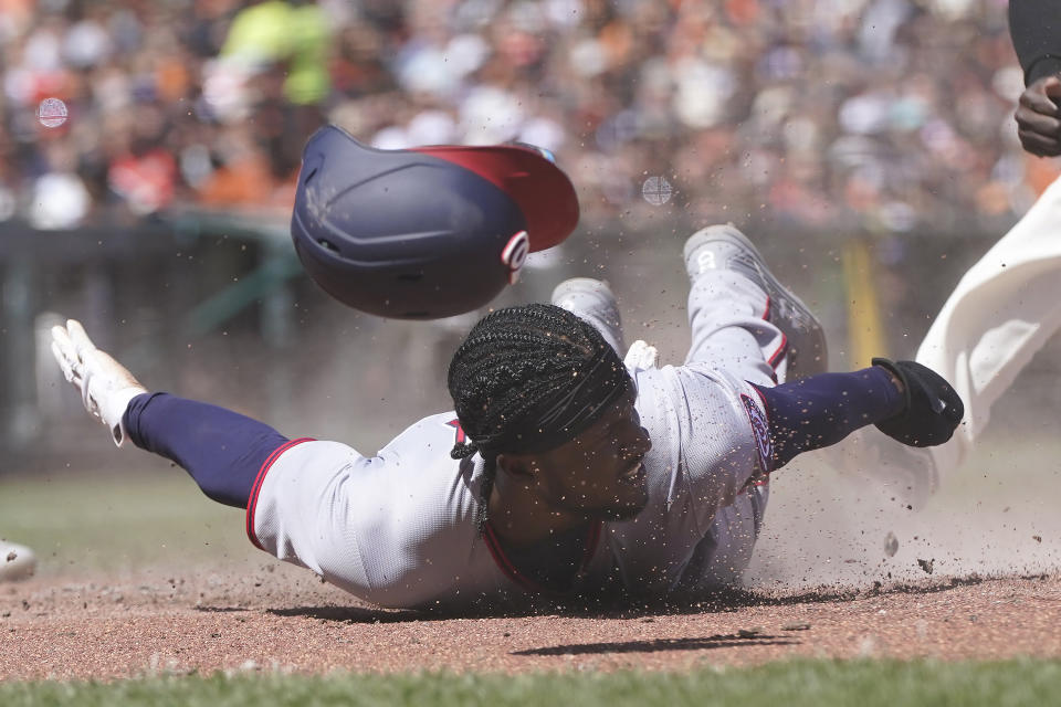 Washington Nationals' Lucius Fox slides home to score against the San Francisco Giants during the sixth inning of a baseball game in San Francisco, Sunday, May 1, 2022. (AP Photo/Jeff Chiu)