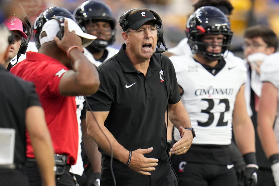 Cincinnati coach Scott Satterfield, center, yells to players during the first half of the team's NCAA college football game against Pittsburgh in Pittsburgh on Saturday, Sept. 9, 2023. (AP Photo/Gene J. Puskar)