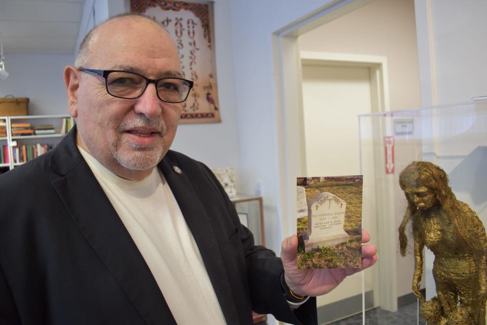 Michael Manoog Kaprielian, a founding member of the board of the Armenian Historical Association of Rhode Island, holds a photo of the grave of the Rev. Vaghenag Sisagian, a priest who served the Armenian community. He's buried in Providence's North Burial Ground.