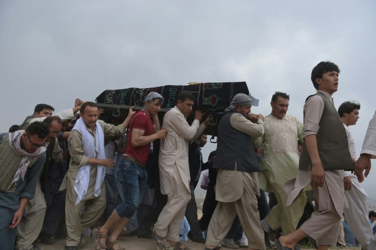 Mourners carry the coffin of one of the 80 people killed in a twin suicide attack in Kabul, on July 24, 2016