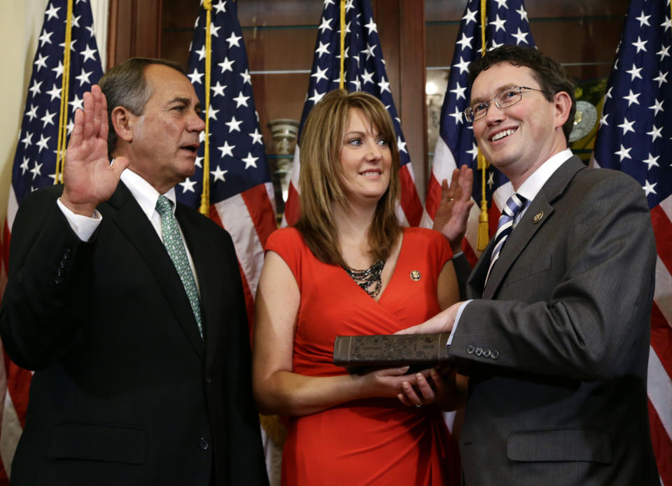 FILE - House Speaker John Boehner of Ohio, left, performs a mock swearing in for Rep. Thomas Massie, R-Ky., right, with his wife Rhonda Massie, center, on Capitol Hill Tuesday, Nov. 13, 2012, in Washington. Rhonda Massie, the wife of U.S. Rep. Thomas Massie, has died, the Kentucky congressman announced Friday, June 28, 2024, on social media. (AP Photo/Alex Brandon, File)