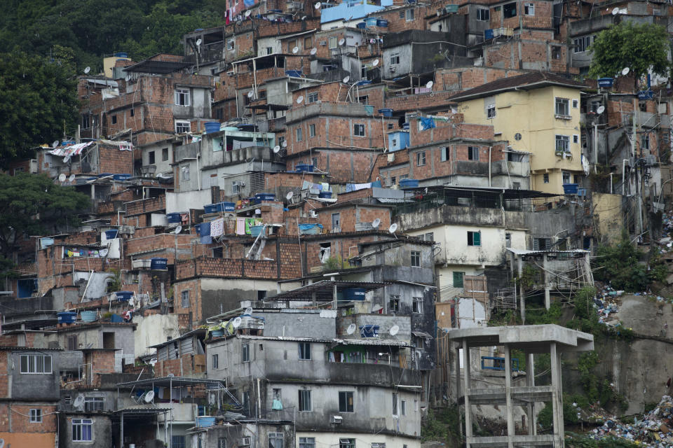 View of the Rocinha slum in Rio de Janeiro, Brazil, Monday, Feb.17, 2014. Police in Rio de Janeiro are reinforcing patrols in the Brazilian city's biggest slum after a weekend of shootouts. Rocinha is among Rio's "pacified" slums. In 2011, police entered and pushed the ruling drug gang out, and set up a permanent post. The slum pacification program is a key element of Rio's security plans ahead of this year's World Cup and the 2016 Olympics. (AP Photo/Silvia Izquierdo)