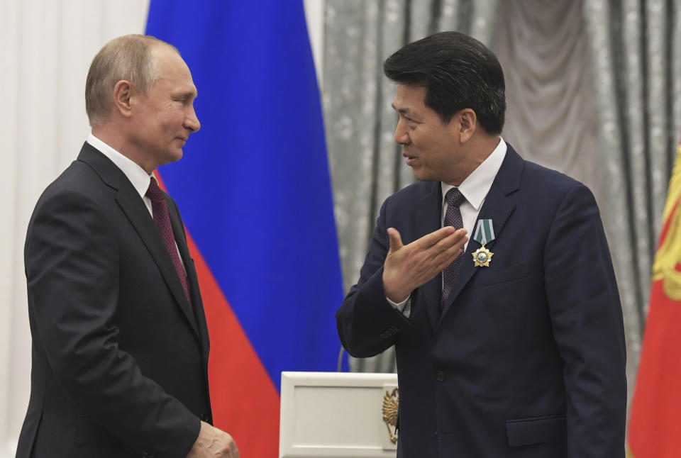 Russian President Vladimir Putin presents a state award to Li Hui at the Kremlin (Dmitry Azarov / Kommersant/Sipa via AP file)