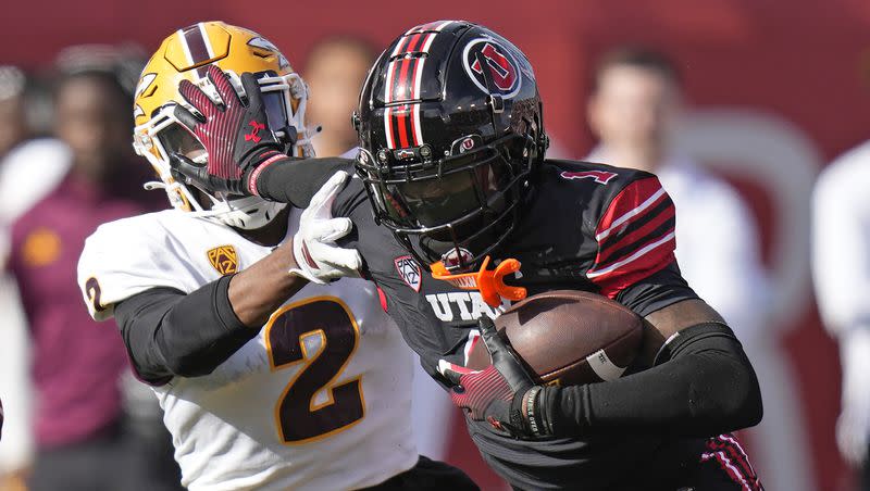 Utah cornerback Miles Battle stiff-arms Arizona State receiver Elijhah Badger after his interception during a game on Nov. 4, 2023, in Salt Lake City. The Ole Miss transfer was a difference maker for the Utes this season.