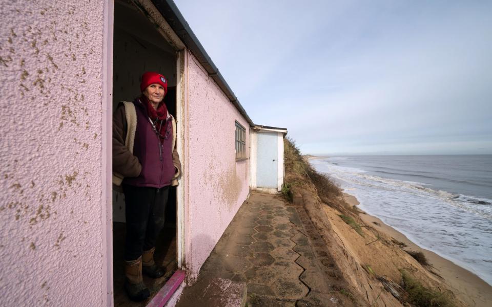 Hemsby resident Sue looks out from her home on the cliff edge - Joe Giddens/PA Wire