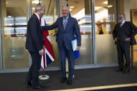 UK Brexit secretary Stephen Barclay, left, is welcomed by European Union chief Brexit negotiator Michel Barnier next to British Ambassador to the EU Tim Barrow, right, before their meeting at the European Commission headquarters in Brussels, Friday, Oct. 11, 2019. (AP Photo/Francisco Seco, Pool)