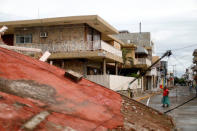 A resident walks near debris and destroyed houses after an earthquake struck the southern coast of Mexico late on Thursday, in Juchitan, Mexico, September 10, 2017. REUTERS/Edgard Garrido