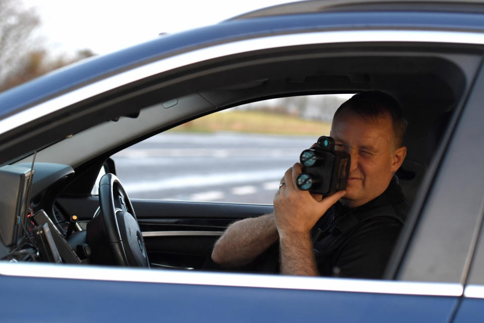 WEYMOUTH, ENGLAND - DECEMBER 06: Sgt. Jephcott from the No Excuse team uses a speed gun on the A35 as he patrols Dorset as part of the No Excuse campaign, on December 06, 2019 in Weymouth, England. The initiative is part of a force wide Christmas drink drive campaign with a fast-track policy of bringing drink drivers before a court within a week of the offence as well as the wider work of the No Excuse campaign. (Photo by Finnbarr Webster/Getty Images)