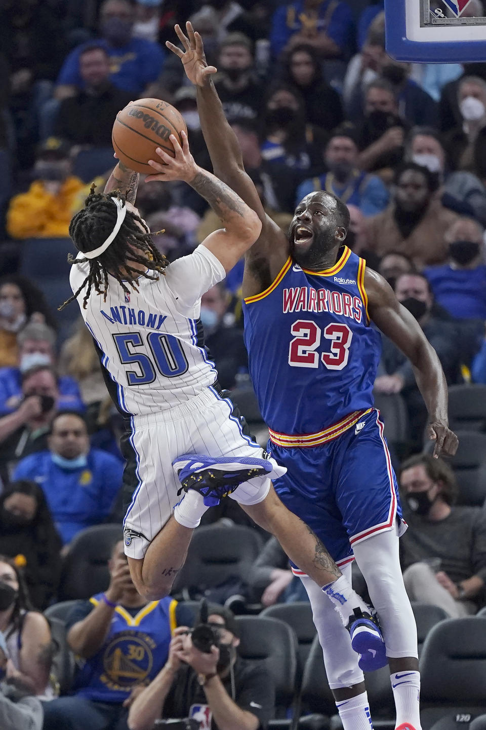 Orlando Magic guard Cole Anthony (50) shoots against Golden State Warriors forward Draymond Green (23) during the first half of an NBA basketball game in San Francisco, Monday, Dec. 6, 2021. (AP Photo/Jeff Chiu)