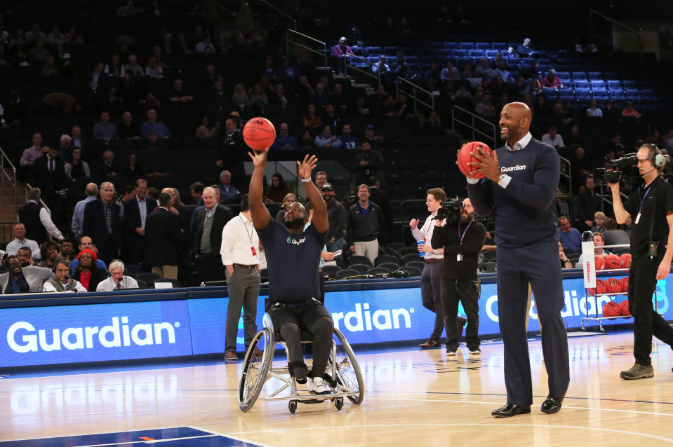 Hall of Fame center Alonzo Mourning plays a game of HORSE with wheelchair basketball star Chris Saint-Remy during the 2K Empire Classic at Madison Square Garden. (Stuart Ramson/AP Images for Guardian Life Insurance)