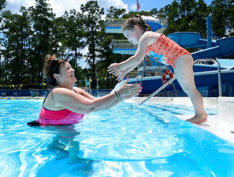 Penny Gutierrez, who is from Michigan and is visiting her daughter who goes to the University of Florida, waits for her granddaughter Skylar Kirkman, 3, to jump off the edge of the pool into her arms in the H. Spurgeon Cherry Pool at Westside Park in Gainesville, Fla., May 22, 2019. With temperatures in the middle 90's today and expected to climb to the 100's locals are looking for fun things to do to beat the heat and swimming at any of the city pools is one cool answer.