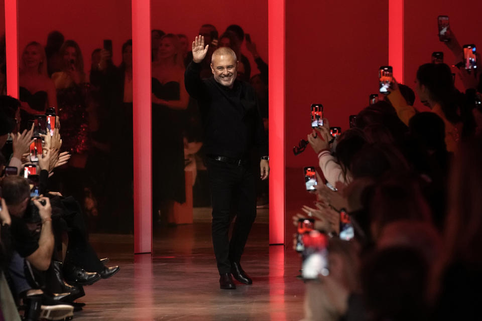 Designer Elie Saab waves after his Haute Couture Spring-Summer 2024 collection presented in Paris, Wednesday, Jan. 24, 2024. (AP Photo/Christophe Ena)