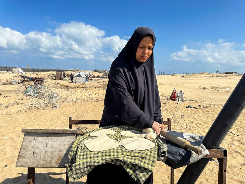 Displaced Palestinians take shelter at the border with Egypt, during an Israeli military operation, in Rafah