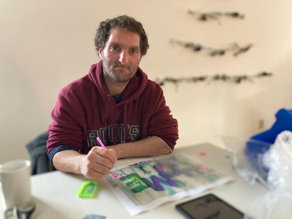 Shawn Robichaud, one of the first people living at the farm, works on an art piece in the main farmhouse. He said his motivation to recover is to reunite with his two children.