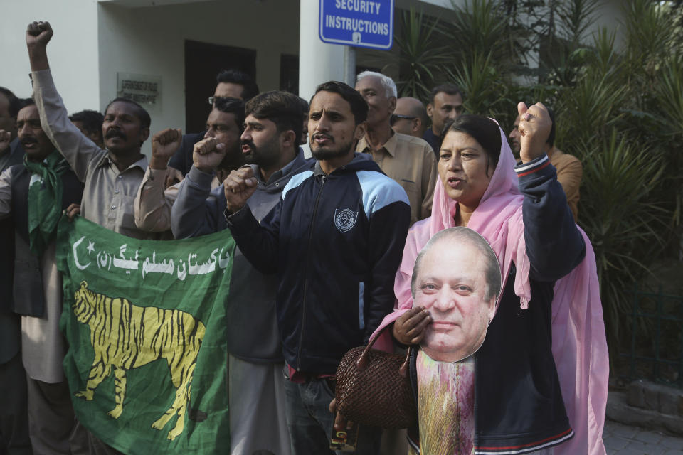 Supporters of Pakistan's ailing former Prime Minister Nawaz Sharif shout slogans at an airport in Lahore, Pakistan, Tuesday, Nov. 19, 2019. Sharif has arrived at the airport to board a plane after a court granted him permission to leave for four weeks abroad for medical treatment. (AP Photo/K.M. Chaudary)