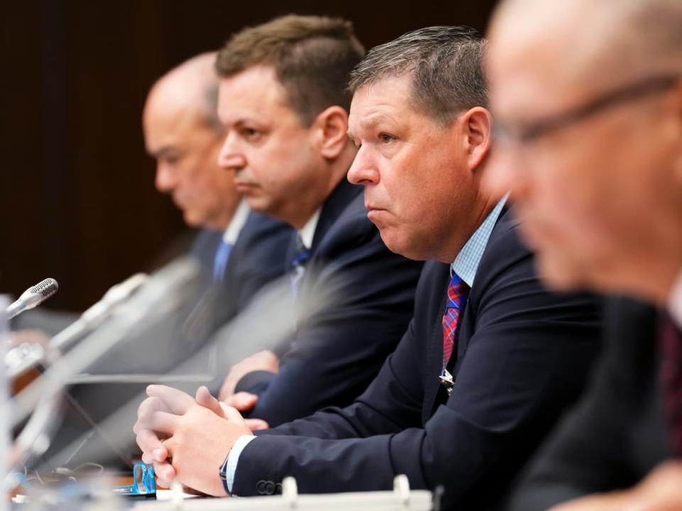 Hockey Canada president and CEO Scott Smith, second from right, is seen during parliamentary hearings last week where MPs from multiple parties called on him to resign over his organization's handling of sexual assault claims.  (Sean Kilpatrick/The Canadian Press - image credit)