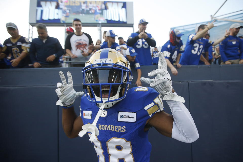 Winnipeg Blue Bombers wide receiver Rasheed Bailey celebrates a touchdown by teammate Kenny Lawler against the Hamilton Tiger-Cats during the first half of a Canadian Football League game Thursday, Aug. 5, 2021, in Winnipeg, Manitoba. (John Woods/The Canadian Press via AP)