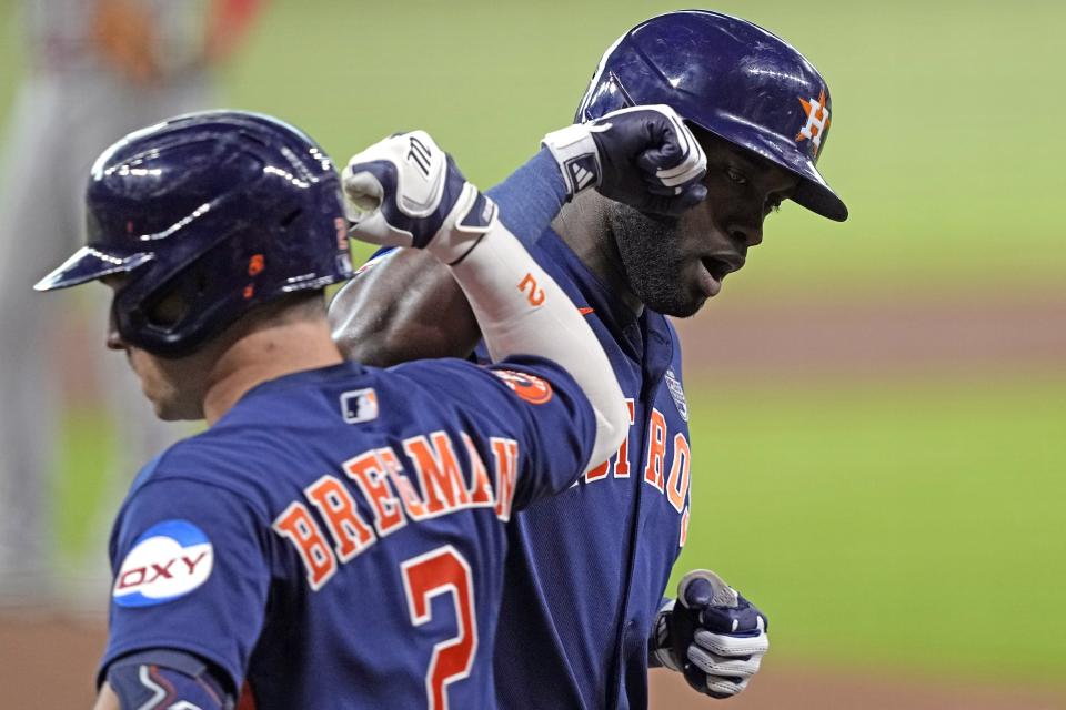 Houston Astros' Yordan Alvarez, right, celebrates with Alex Bregman (2) after hitting a two-run home run against the Los Angeles Angels during the first inning of a baseball game Friday, June 2, 2023, in Houston. (AP Photo/David J. Phillip)