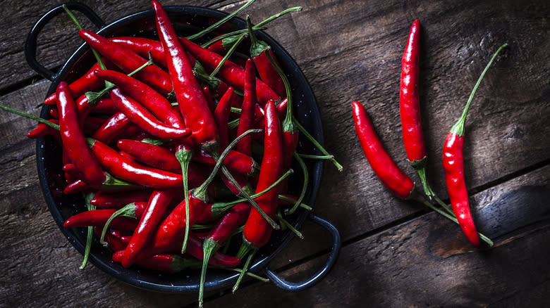 Spicy red peppers on a black plate